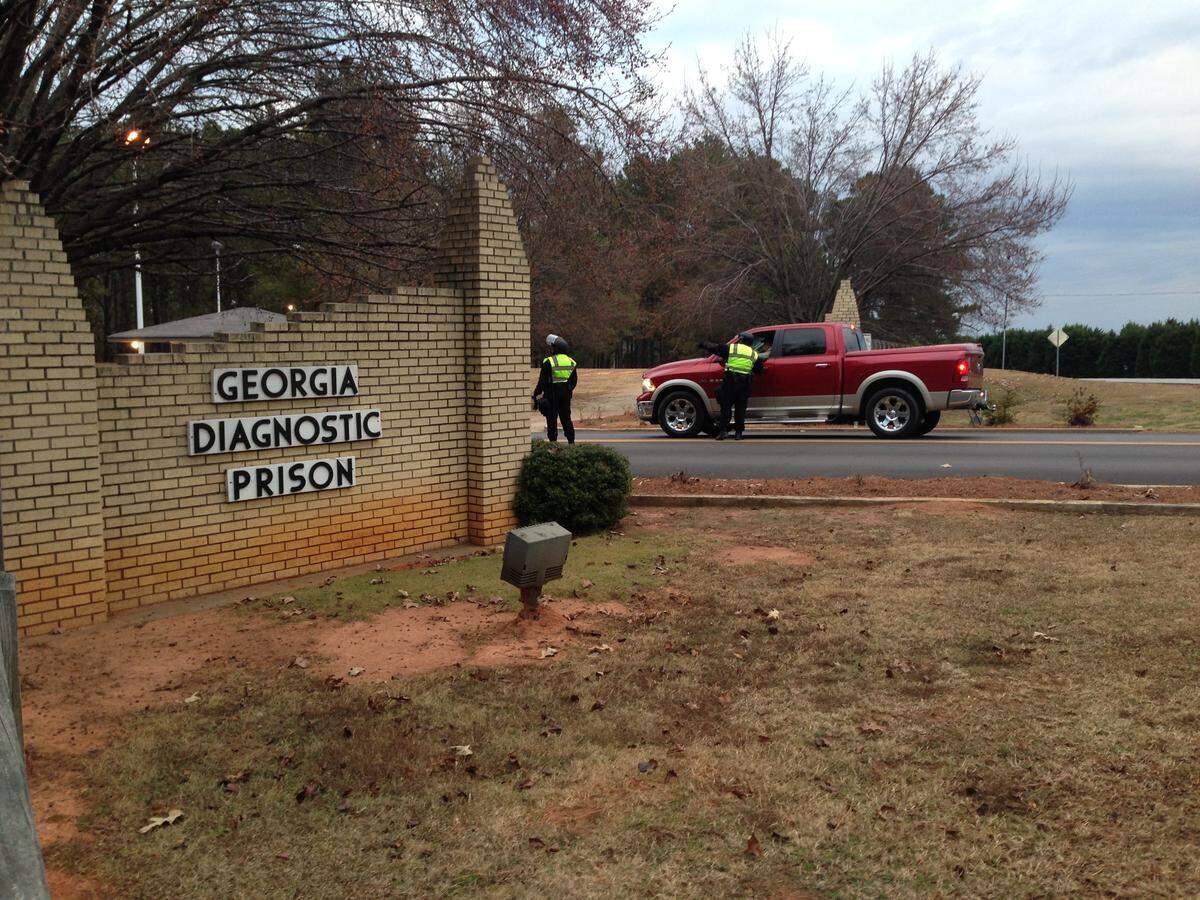Georgia Department of Corrections officers check vehicles going into the Georgia Diagnostic and Classification Center in Jackson prior to Tuesday’s scheduled execution of Robert Wayne Holsey.