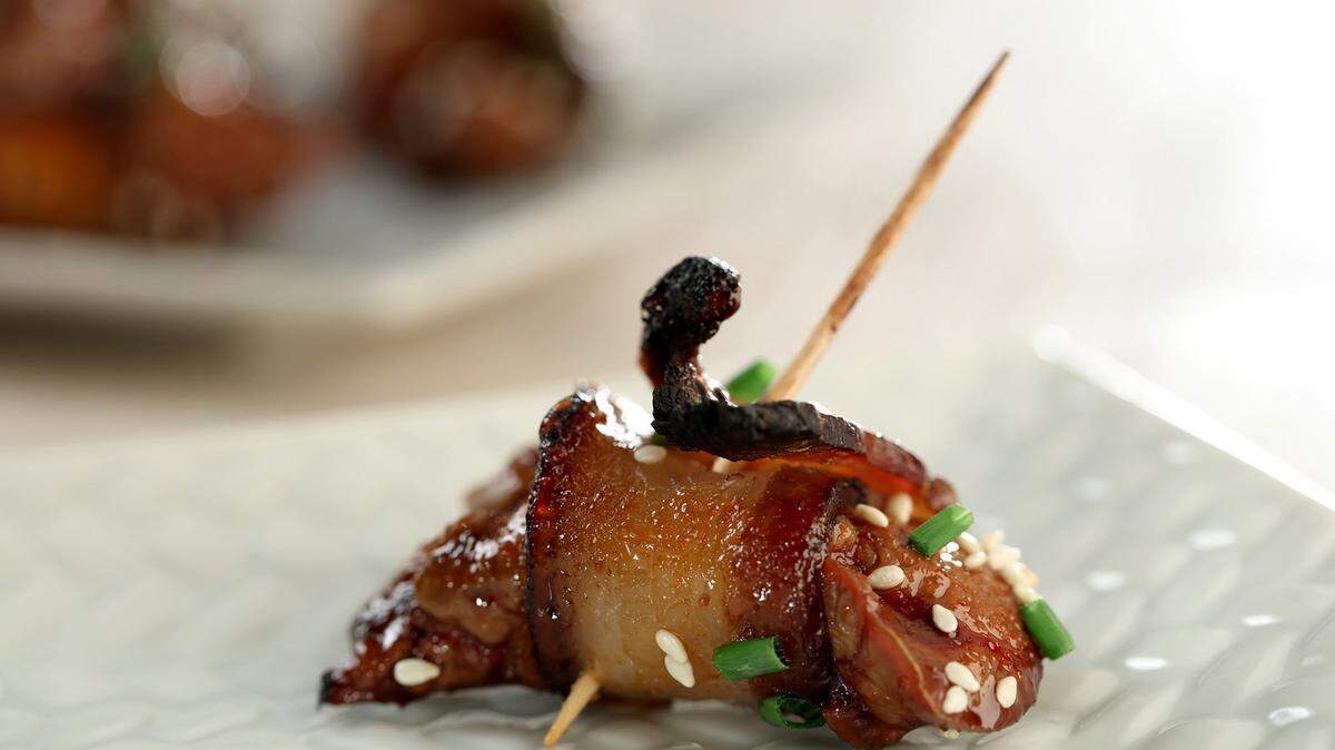 Start the meal with chicken livers wrapped in crispy bacon and glazed with Sriracha and honey.