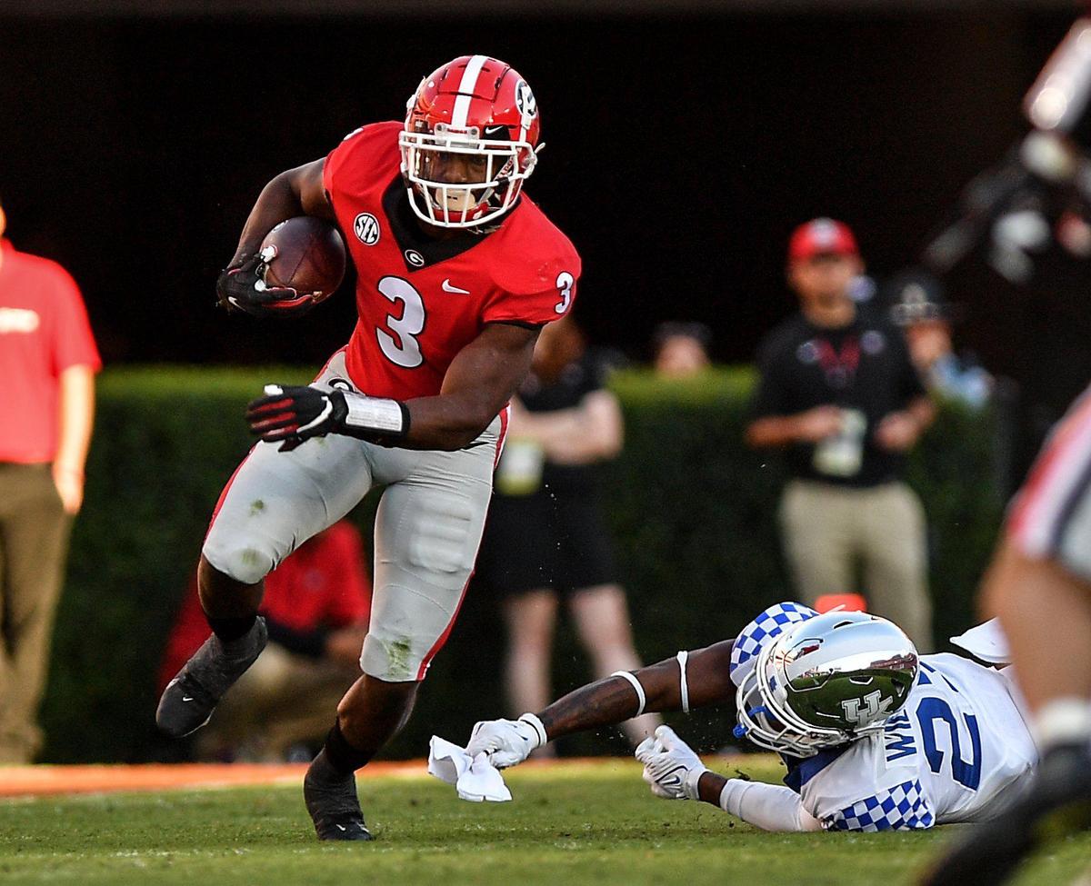 DONN RODENROTH,Athens, Georgia, 10/16/2021: Georgia’s Zamir White slips tackle and heads for a big first down Saturday against Kentucky.