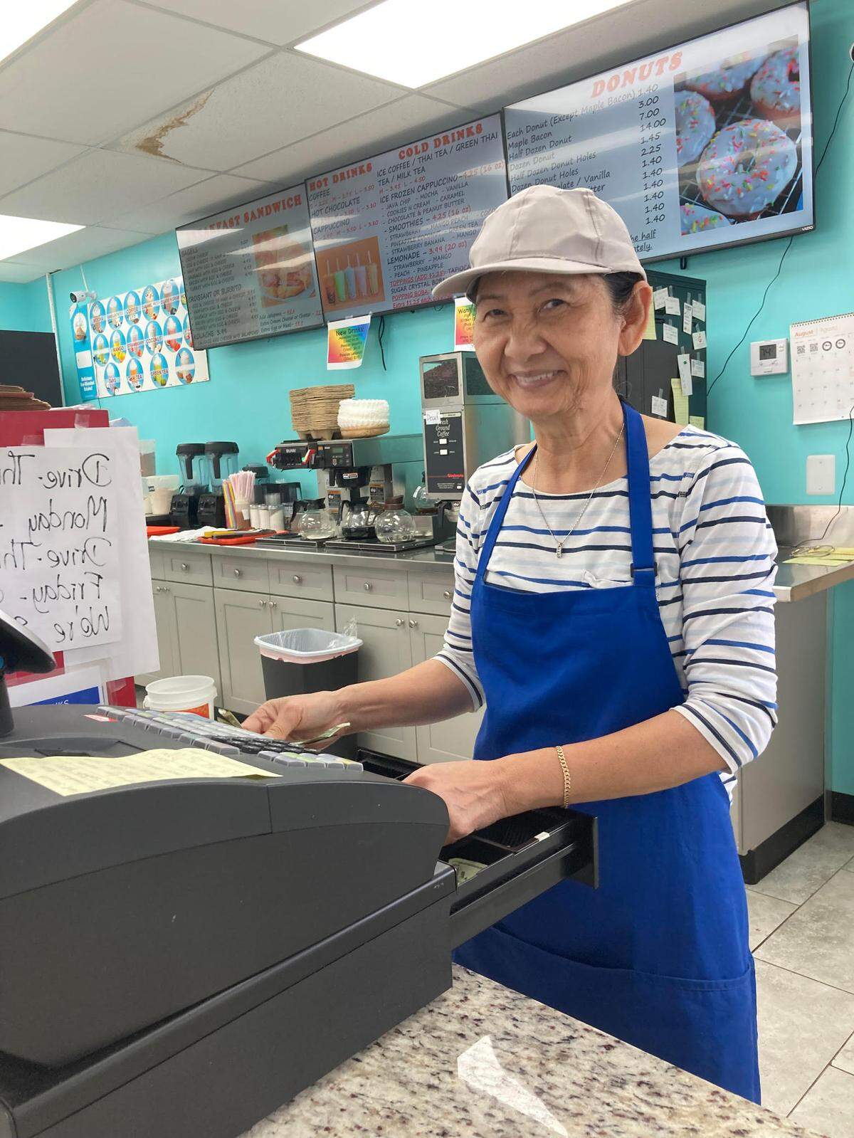Porcaou Seng, a Cambodian native, works the cash register at Ray’s Donuts.
