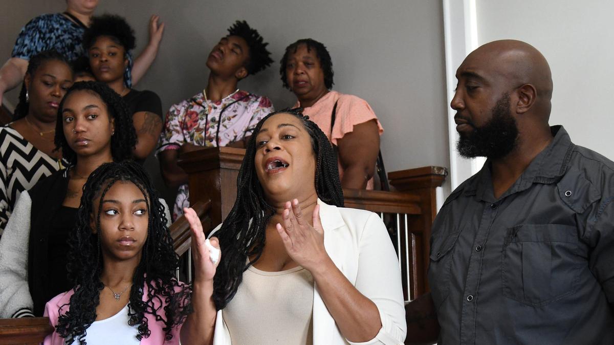 Timberly Stone (middle), mother of Gabriel Stone, speaks surrounded by family members during a press conference at Forrest B. Johnson law firm on Tuesday, July 30, 2024, in Macon, Georgia. Fourteen year old Gabriel Stone died on July 22 when a concrete wall collapsed on him at the Robins Air Force Base pool. Atlanta-based law firm Edmond & Lindsay, LLP. plan to conduct their own independent investigation into his death.