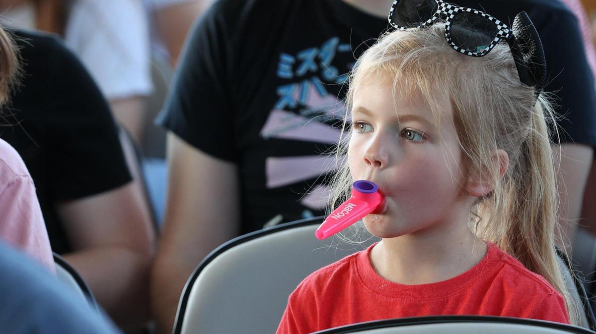 Presley Wade, 5, plays the kazoo before the start of the Guinness World Record attempt for largest kazoo ensemble on Friday, March 28, 2025, at the Atrium Health Amphitheater in Macon, Georgia. Thousands of participants came out for the event, but their third record attempt failed to meet the mark for the record.