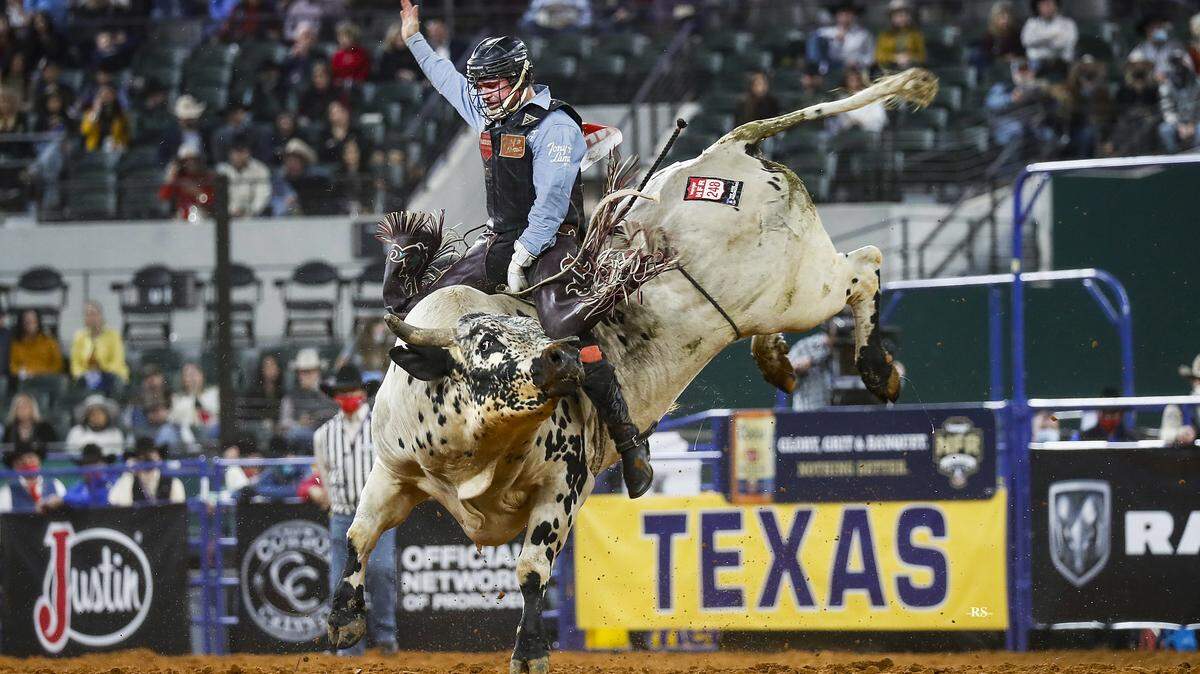A competitor rides a bucking bull at the National Finals Rodeo 2020 in Arlington, Texas.