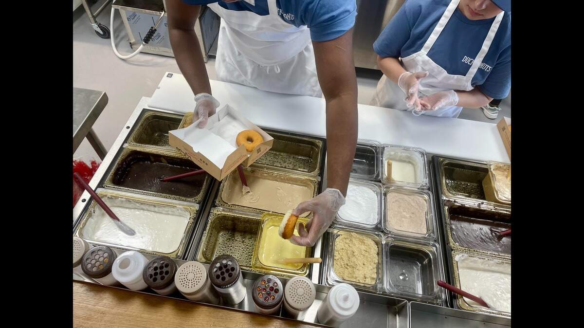 Customers can select coatings, toppings and drizzle for their fresh-made, warm doughnuts at the new Duck Donuts in Warner Robins. The new spot celebrates its grand opening Saturday.