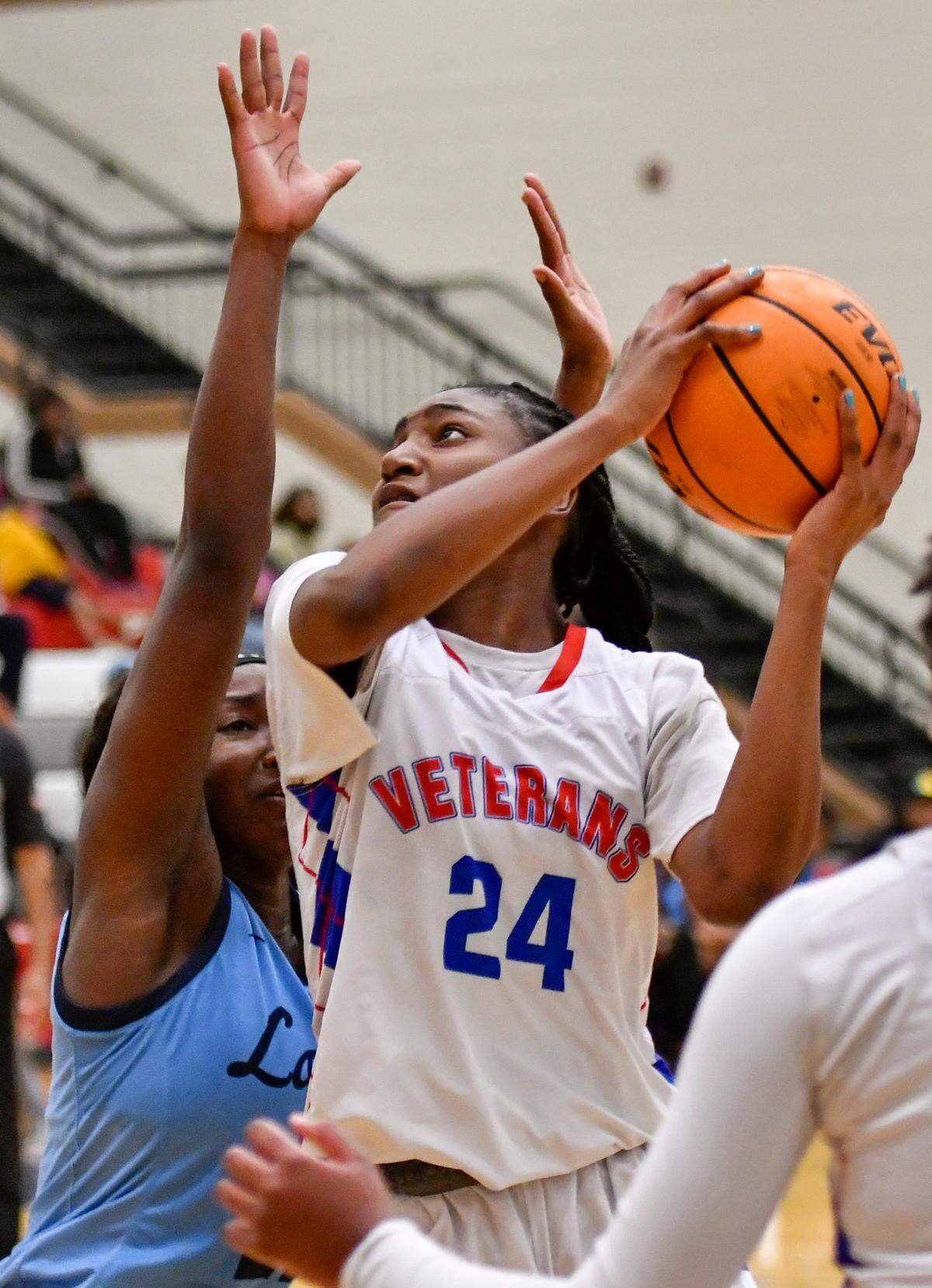 Veterans’ Gabby Minus (24) puts up a shot over a Lovejoy defender during their GHSA second round playoff game Friday night. Lovejoy defeated Veterans 72-53.