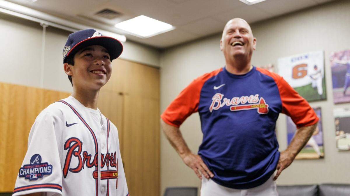 Jackson Hall (left) poses with Atlanta Braves manager Brian Snitker during his Make-A-Wish tour of the Braves’ stadium in July 2022. The tour was filmed and aired on ESPN July 18.