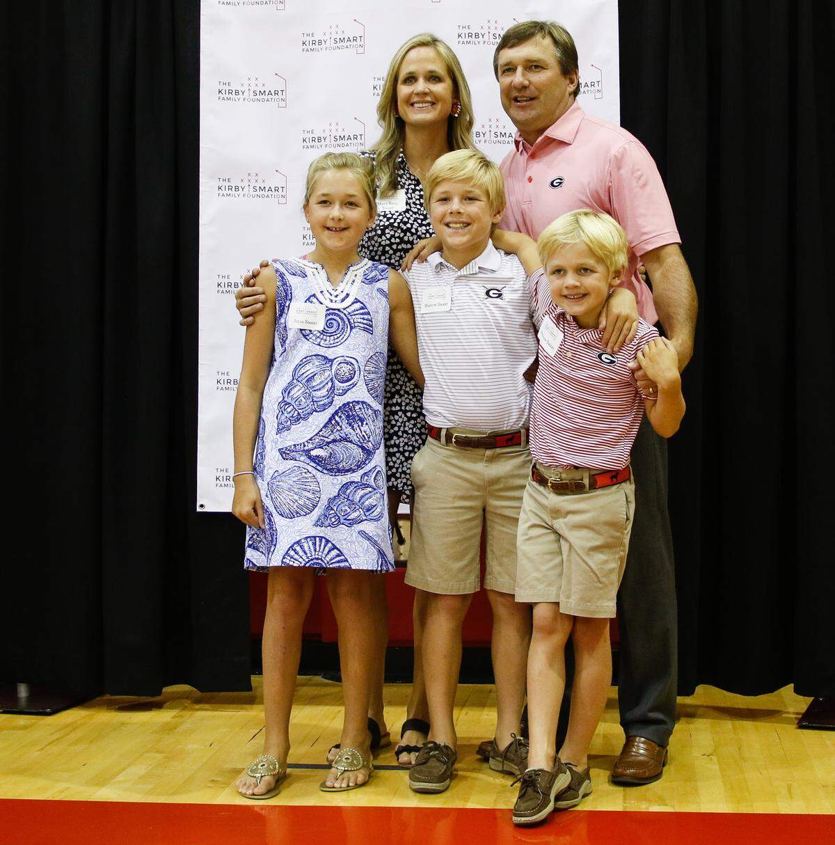 Georgia head coach Kirby Smart poses for a picture with his family at the CKS Foundation event in Stegeman Coliseum in Athens, Ga., on Wednesday, Aug., 8, 2018.