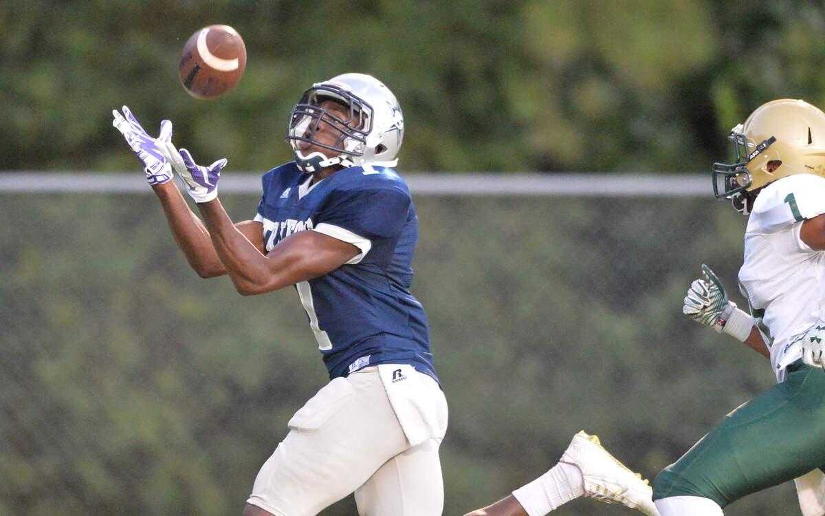 EVAN RODENROTH/For The TELEGRAPH,Warner Robins, Georgia, 09/18/2015: Stratford Eagle Quintez Cephus huals in a pass from quarterback 
 Sim Patrick Friday night against Aquinas Fighting Irish.