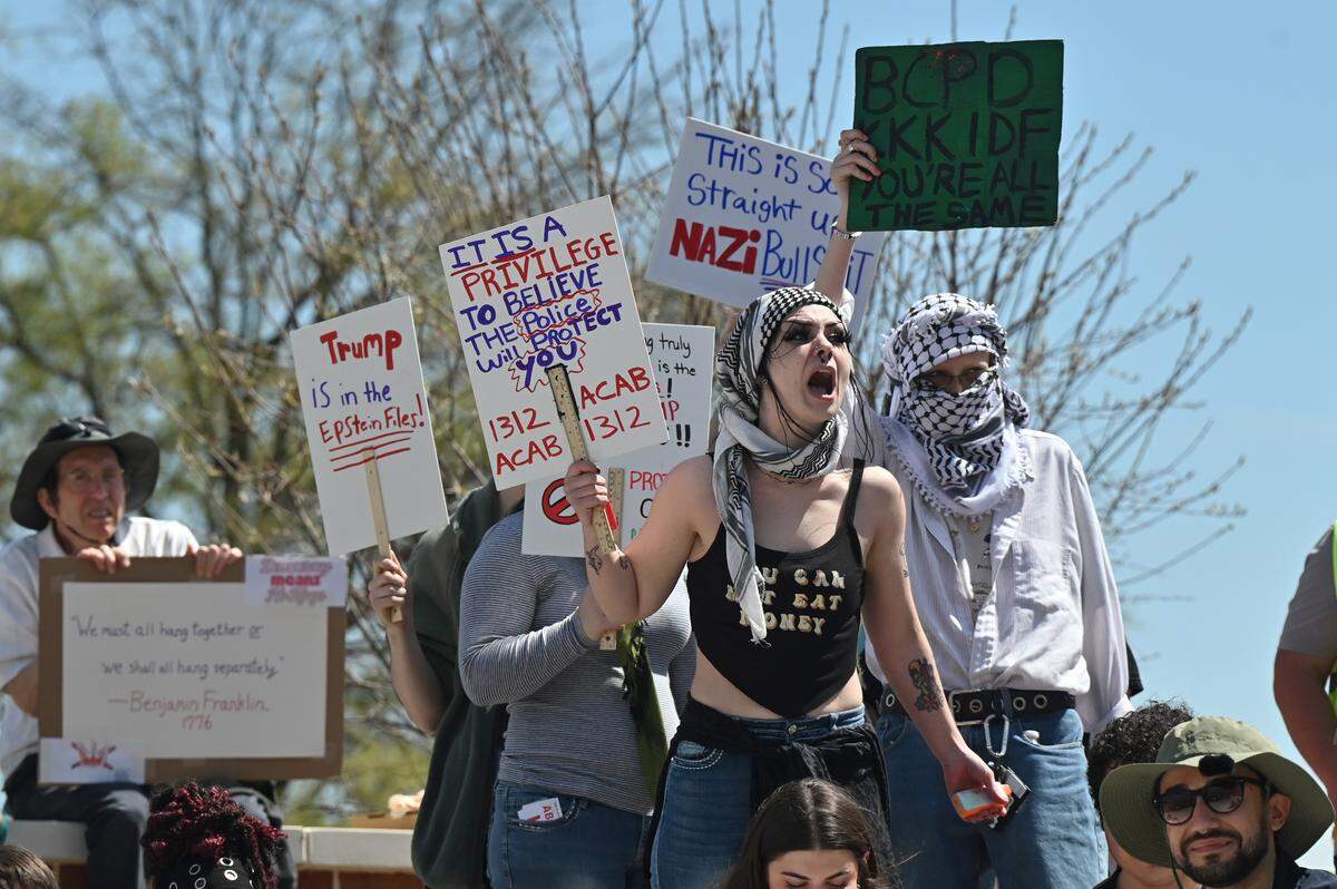 Middle Georgia Democratic Socialists of America members yell in protest when Bibb County Sheriff David Davis began speaking at the No Kings Protest on Saturday, March 28, 2026, in downtown Macon, Ga. Several members shouted about conditions at the Bibb County Jail and the sheriff’s office’s cooperation with U.S. Immigration and Customs Enforcement agency.