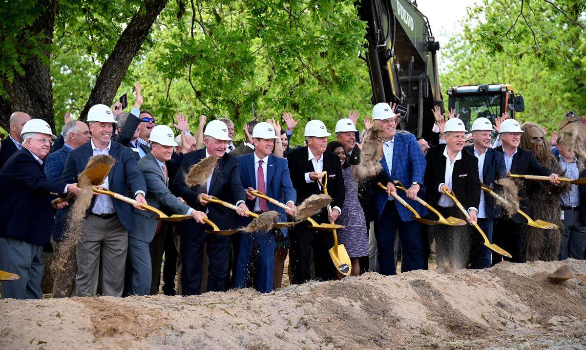 Dignitaries including Governor Brain Kemp, University System of Georgia Chancellor Sonny Perdue and founder Jack Link toss dirt during a groundbreaking April 26, 2022 for a new Jack Link’s meat snacks facility in Perry.