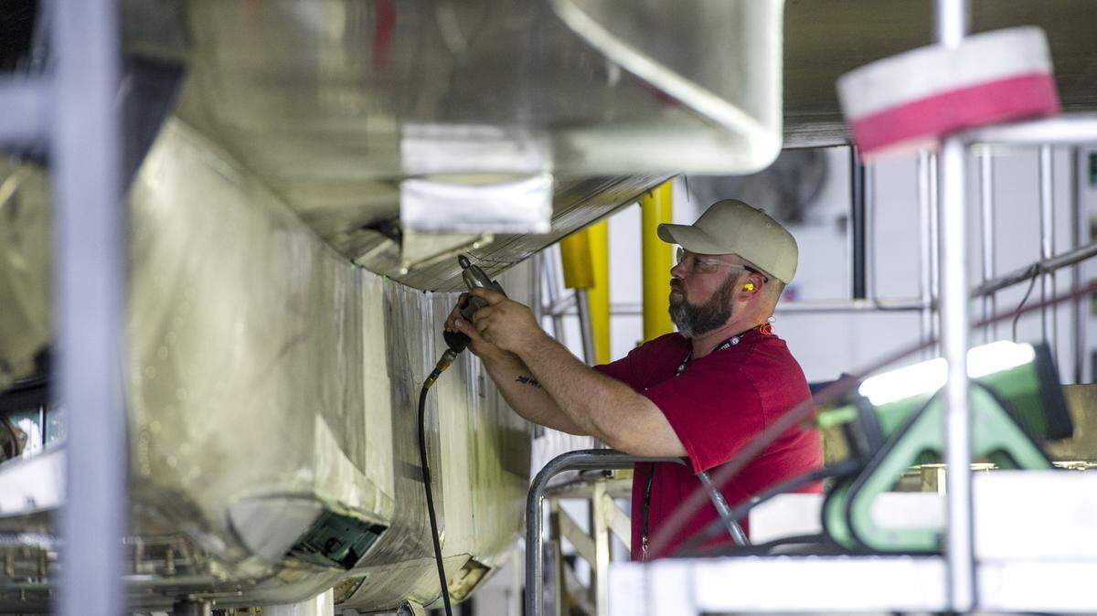 James Hall removes a panel from under the wing of an F-15 being repaired at Robins Air Force Base.