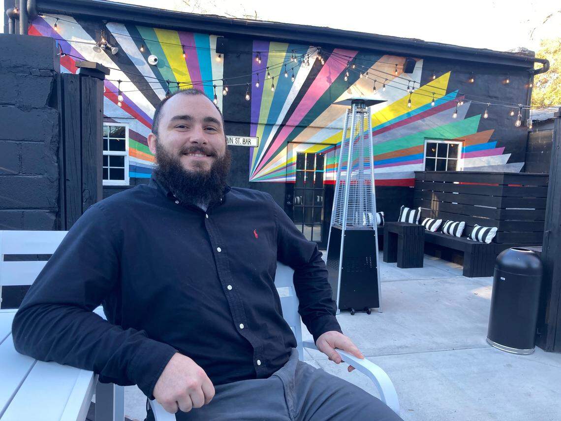 Zach Bibbins, who manages the family’s Main St. Bar in downtown Perry, talks about the vision for the upscale bar that celebrates its grand opening Friday. He’s seated in the outside, fenced in patio in the back of the bar.