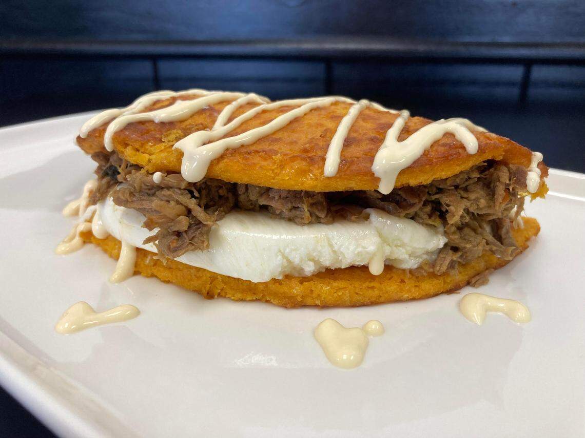 A cachapa filled with shredded meat and cheese with a drizzle of cream at a new restaurant in Warner Robins that serves up Venezuelan cuisine.
