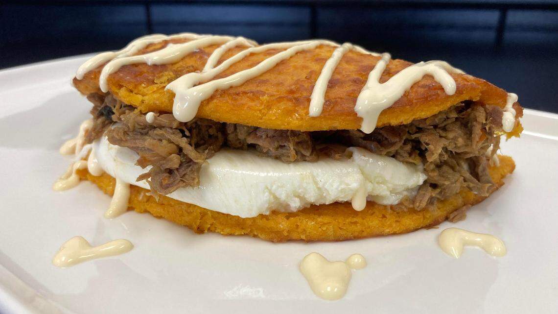 A Cachapa De Carne Mechada filled with shredded meat and cheese with a drizzle of cream at a new restaurant in Warner Robins that serves up Venezuelan cuisine.