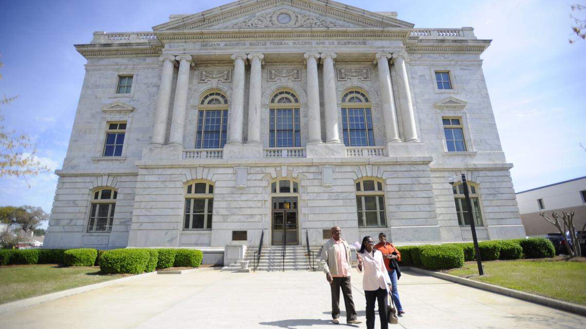 People walk outside the federal courthouse in Macon in this file photo. Despite the federal government shutdown, the U.S. District Court for the Middle District of Georgia will remain open because it has the funds to operate for about three weeks.