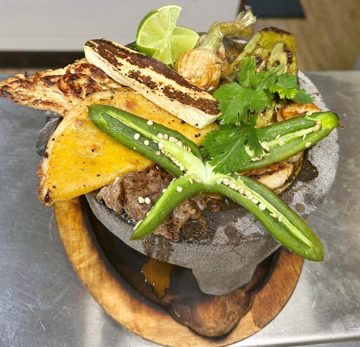 Molcajete Mexicano at Chevo’s Mexican Restaurant at 4921 Riverside Drive, Suite 2. The dish is marinated and seasoned grilled chicken, steak, shrimp, chorizo, Mexican cheese, corn quesadilla, banana pepper and nopal served in a molcajete.