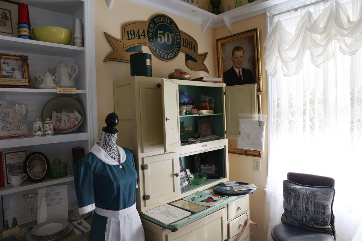 Artifacts, including uniforms and menus, from the New Perry Hotel sit in a permanent exhibit at the Perry Area Historical Museum on Wednesday, Sept. 11, 2024, in Perry, Georgia. The New Perry Hotel stood as a town staple for decades before being demolished this summer. Its history is preserved through a permanent exhibit at the museum.