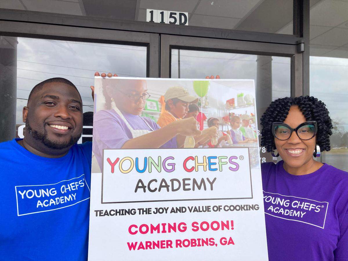 Daphne and Tarell Register, owners of the Young Chefs Academy franchise opening in Warner Robins, outside their new space about to be transformed into a cooking school for children.