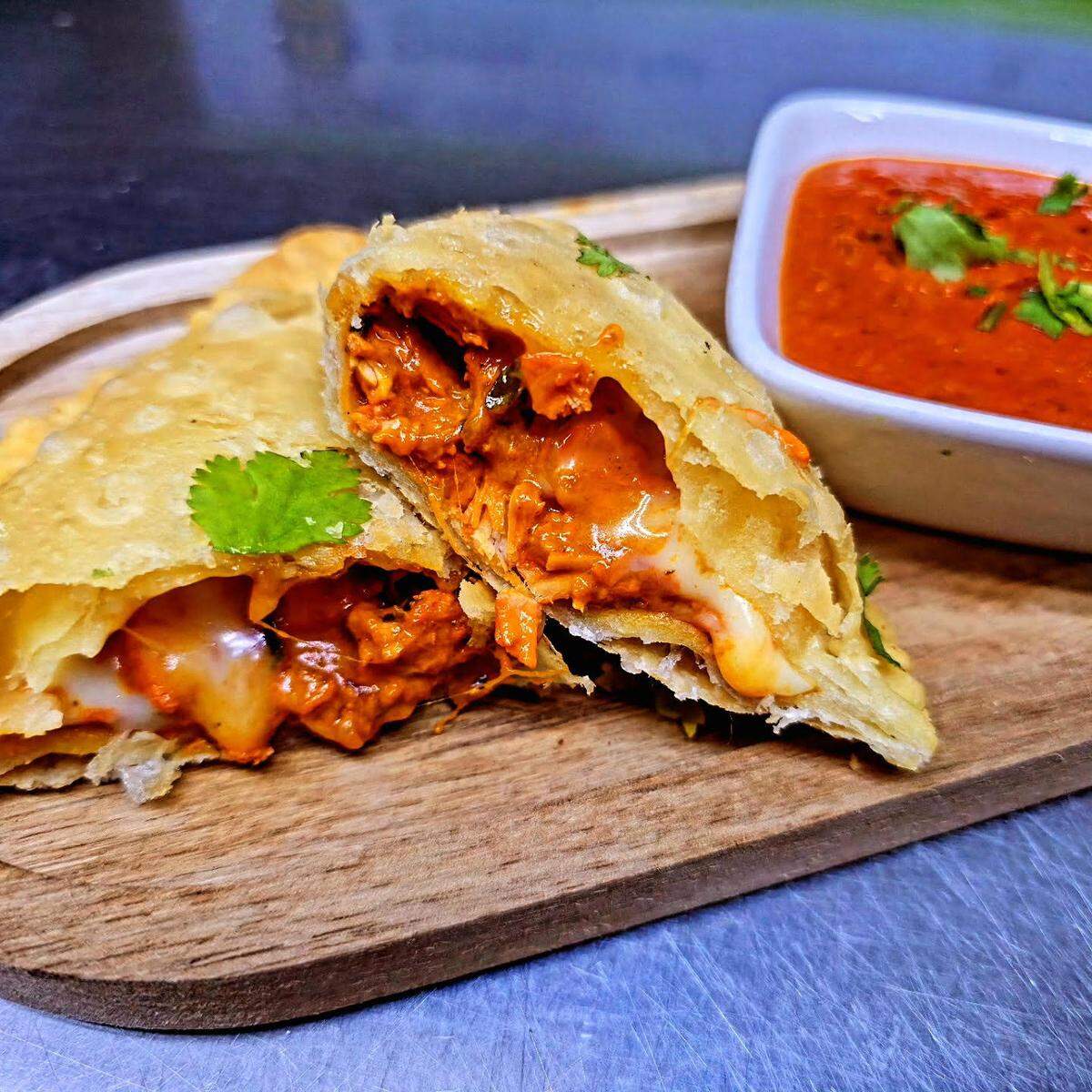“Not Your Mother’s Samosa” from Slice & Spice. Cheese butter chicken samosas served with makhani sauce