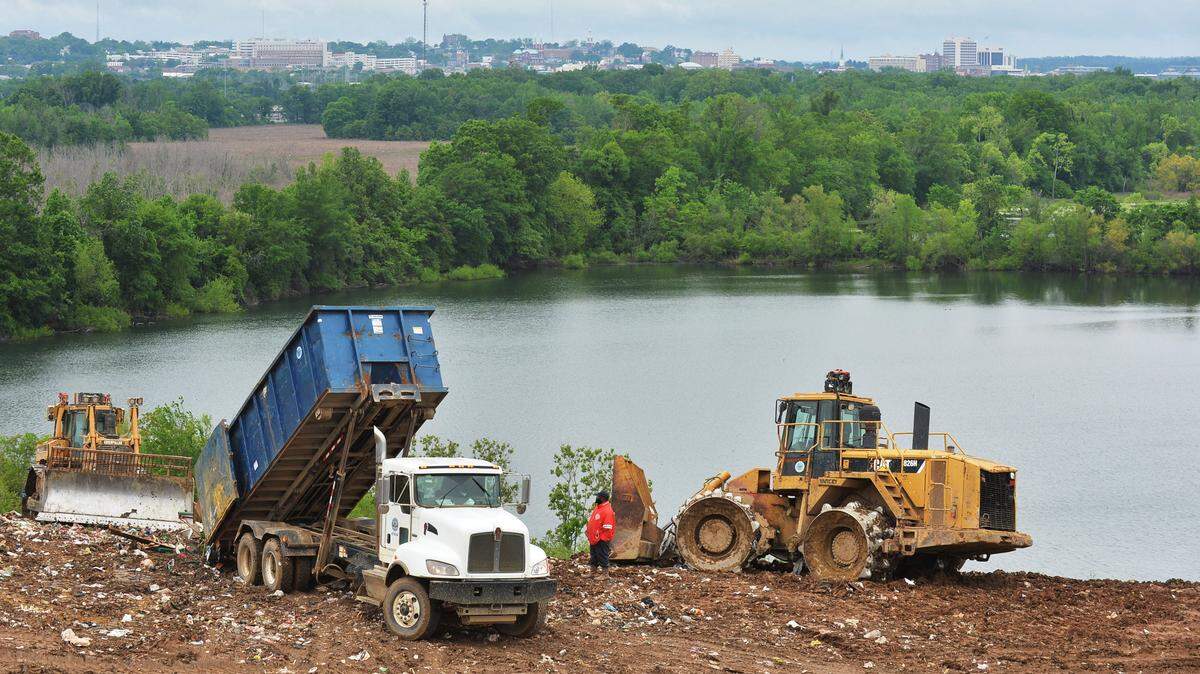 Crews dump and bury garbage high above the swamps of south Bibb County at the city landfill.