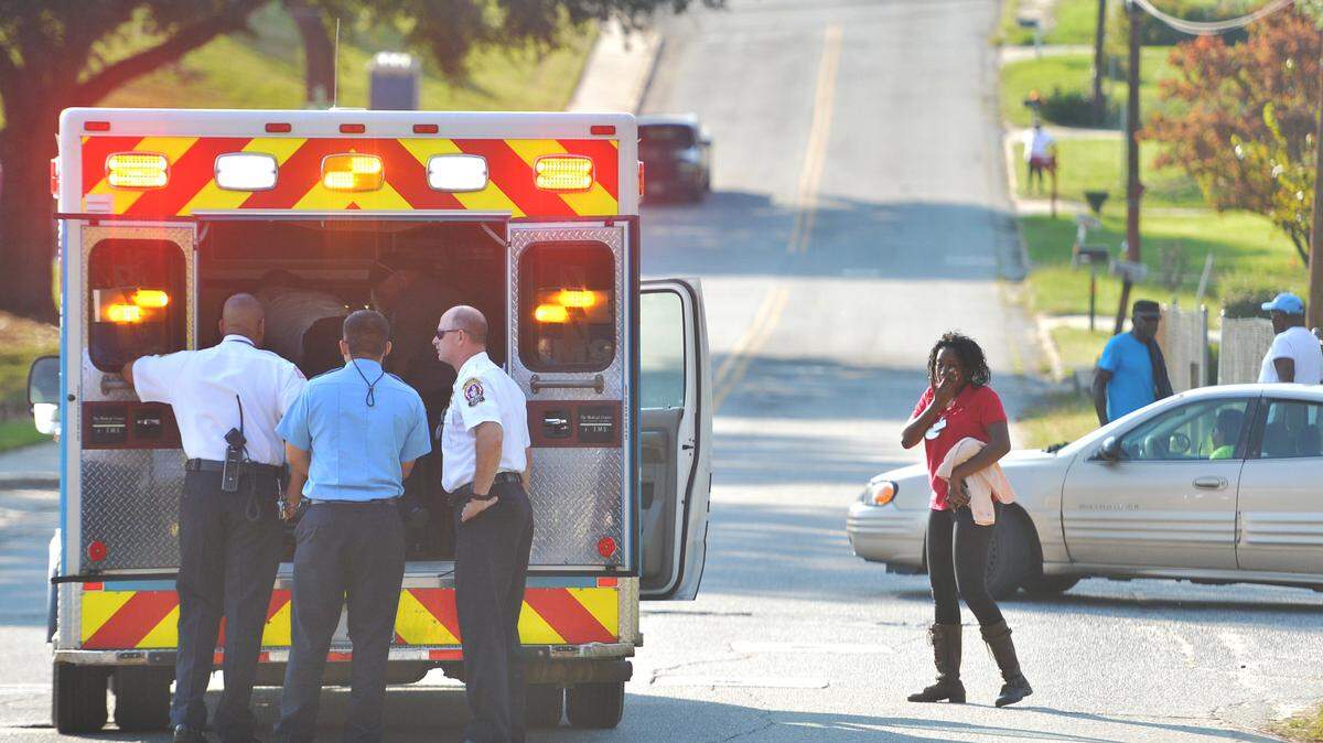 BEAU CABELL/THE TELEGRAPH 
 Macon, Ga., 10/16/2015: Macon-Bibb Fire rescue personnel check on two-year-old Dedruis Jones in the back of an ambulance Friday afternoon. Jones was playing in the front yard with his parents near Ell and E Streets when he ran onto the roadway and was struck by a passing car.