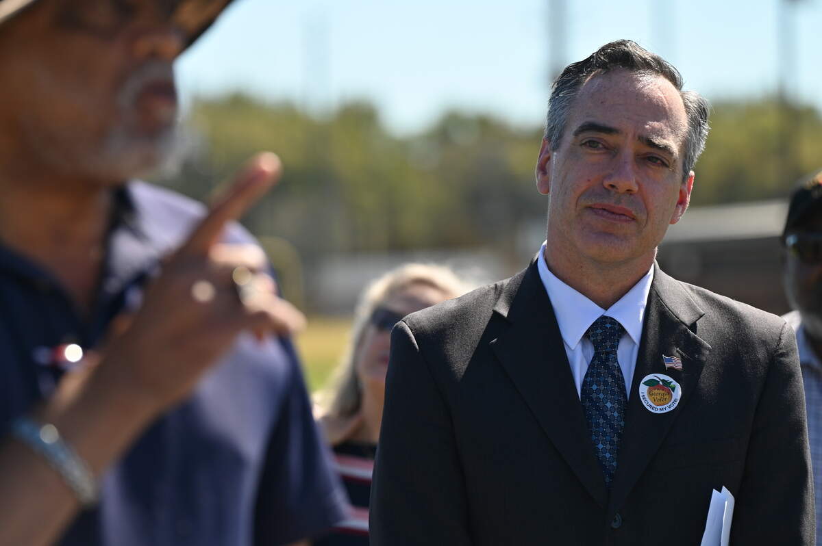 Georgia Public Service Commission Democratic candidate Peter Hubbard (right) listens to remarks by Georgia State Senator David Lucas during a campaign stop on Tuesday, Oct. 14, 2025, outside Carolyn Crayton Park in Macon, Georgia. Democratic candidate Peter Hubbard is running for one of two seats on the Georgia PSC that are on the ballot this November.