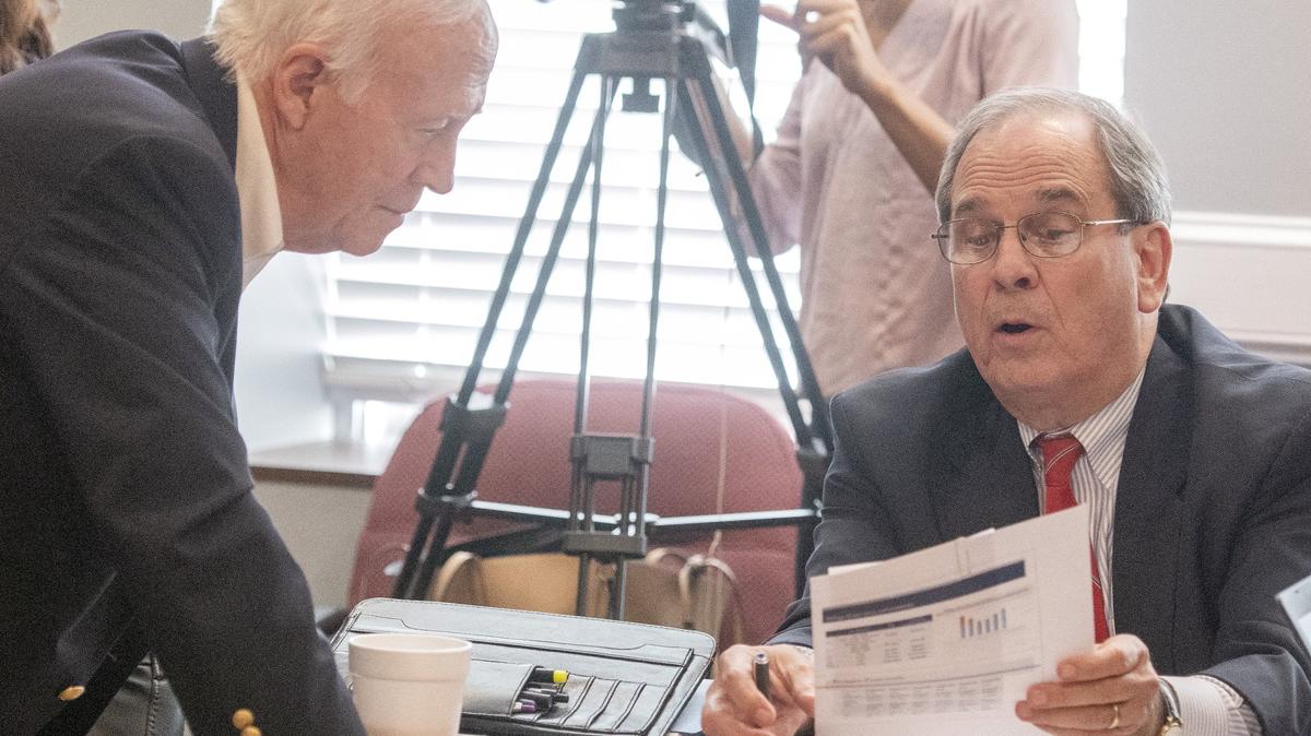 Mayor Robert Reichert, right, talks with Commissioner Mallory Jones after a committee meeting to discuss a property tax increase Aug. 9 at the Macon-Bibb County Government Center.