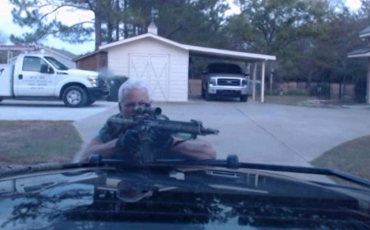 A screen shot from dashcam video taken in the minutes after Ralph Elrod shot and killed Peach County sheriff’s deputies Patrick Sondron and Daryl Smallwood. Elrod, armed with an AR-15 rifle, has his weapon aimed in the direction of police who had rushed to the scene to help the fallen deputies.