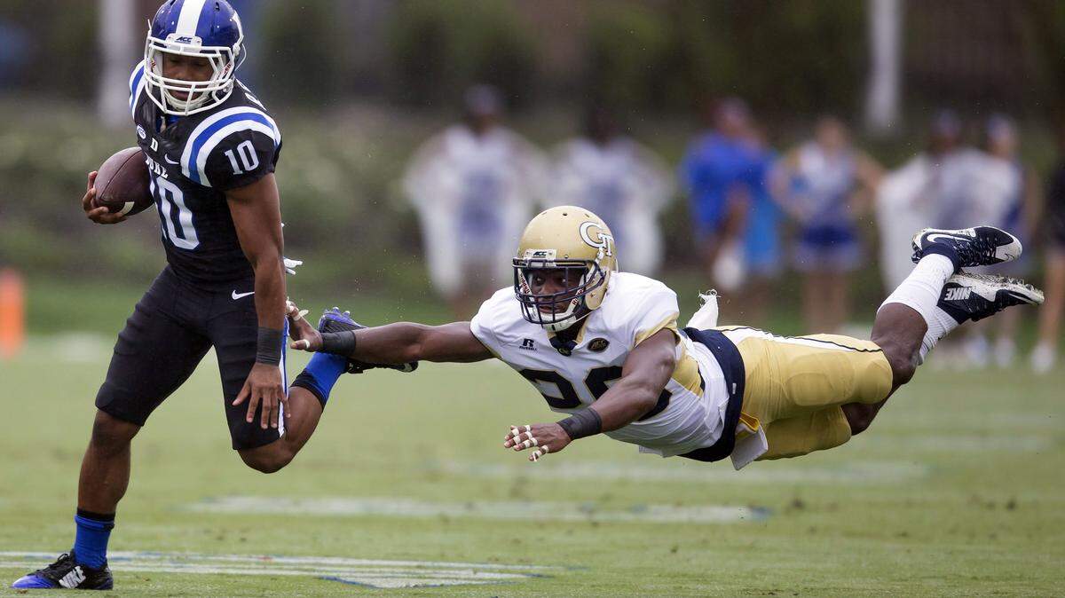 Duke’s Ryan Smith, left, eludes diving Georgia Tech defender and Lamar County product Lawrence Austin during a 68-yard punt return during the first half Saturday.