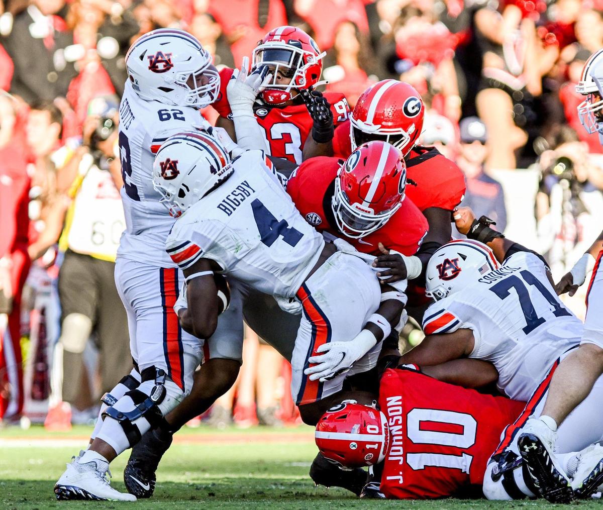 Auburn running back Tank Bigsby get stopped at the line of scrimmage by a host of Georgia defenders Saturday as Auburn fell to Georgia 42-10.