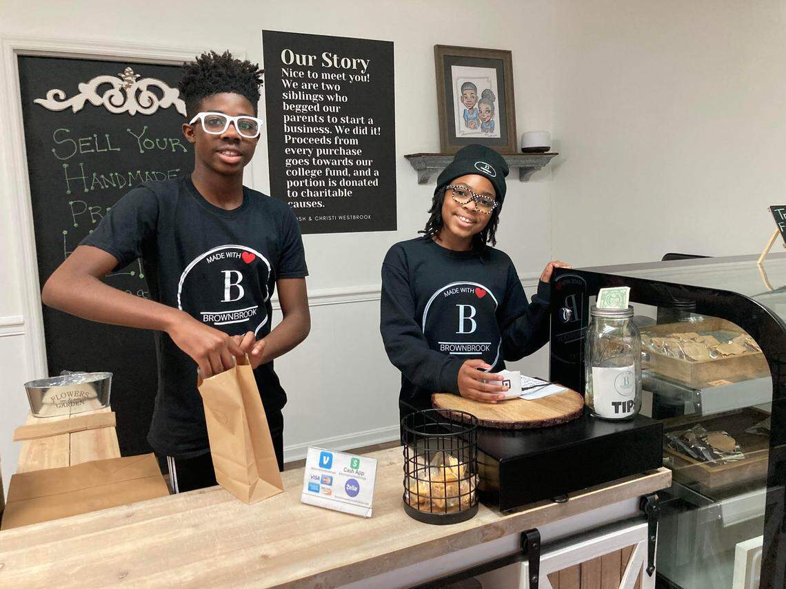 Joshua Westbrook, 13, and his 10-year-old sister, Christi, working behind the counter of their business, the Brownbrook Market at 100 North Houston Lake Boulevard, Suite F, in Centerville.