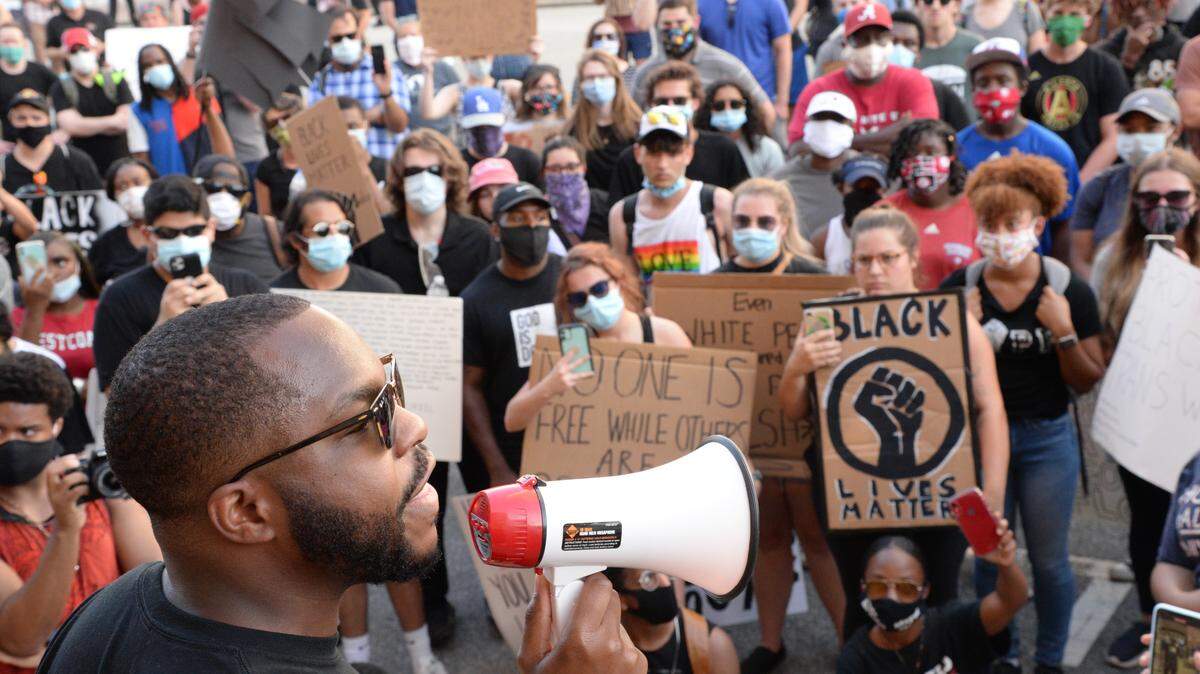 Juawn Jackson reads the names of Black men and women killed by law enforcement officers in the United States over the past few years during a march through downtown Macon in June. The march was one of many vitally important local stories Telegraph reporters told during 2020, thanks to the support of our subscribers.