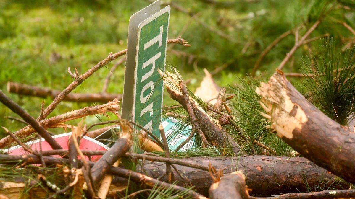 A street and stop sign lays under tree debris at the corner of Thornwood and Crestline drives Wednesday morning after strong storm barreled through Macon Tuesday afternoon.