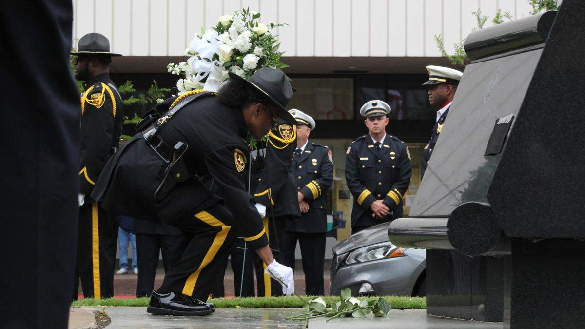 White roses were placed at the foot of the Public Safety Memorial in Downtown Macon, honoring those who passed in the line of duty.