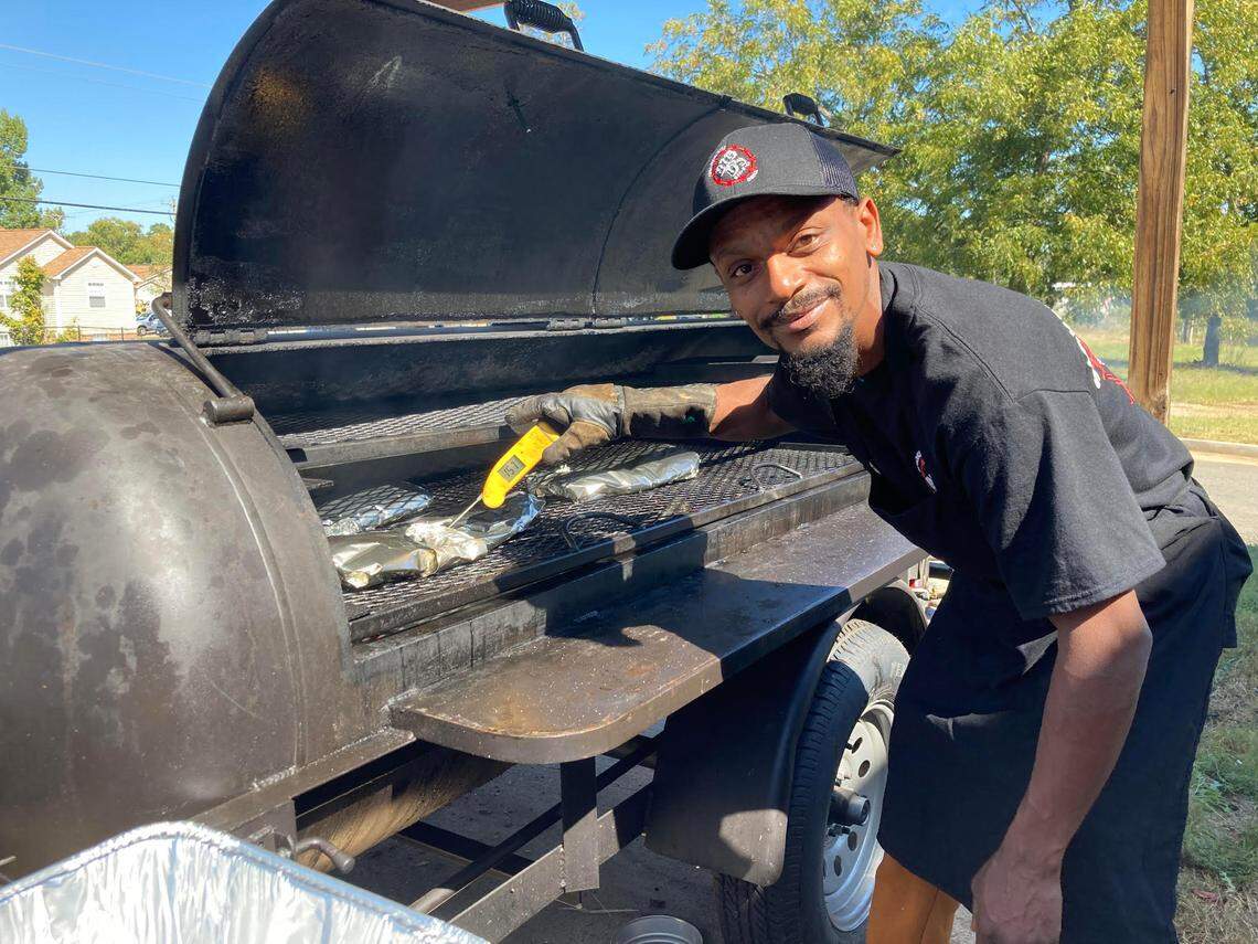 Freddy Smith checks the temperature of the ribs on the grill at Big D’s Bar-B-Q at 280 Carl Vinson Parkway in Warner Robins.
