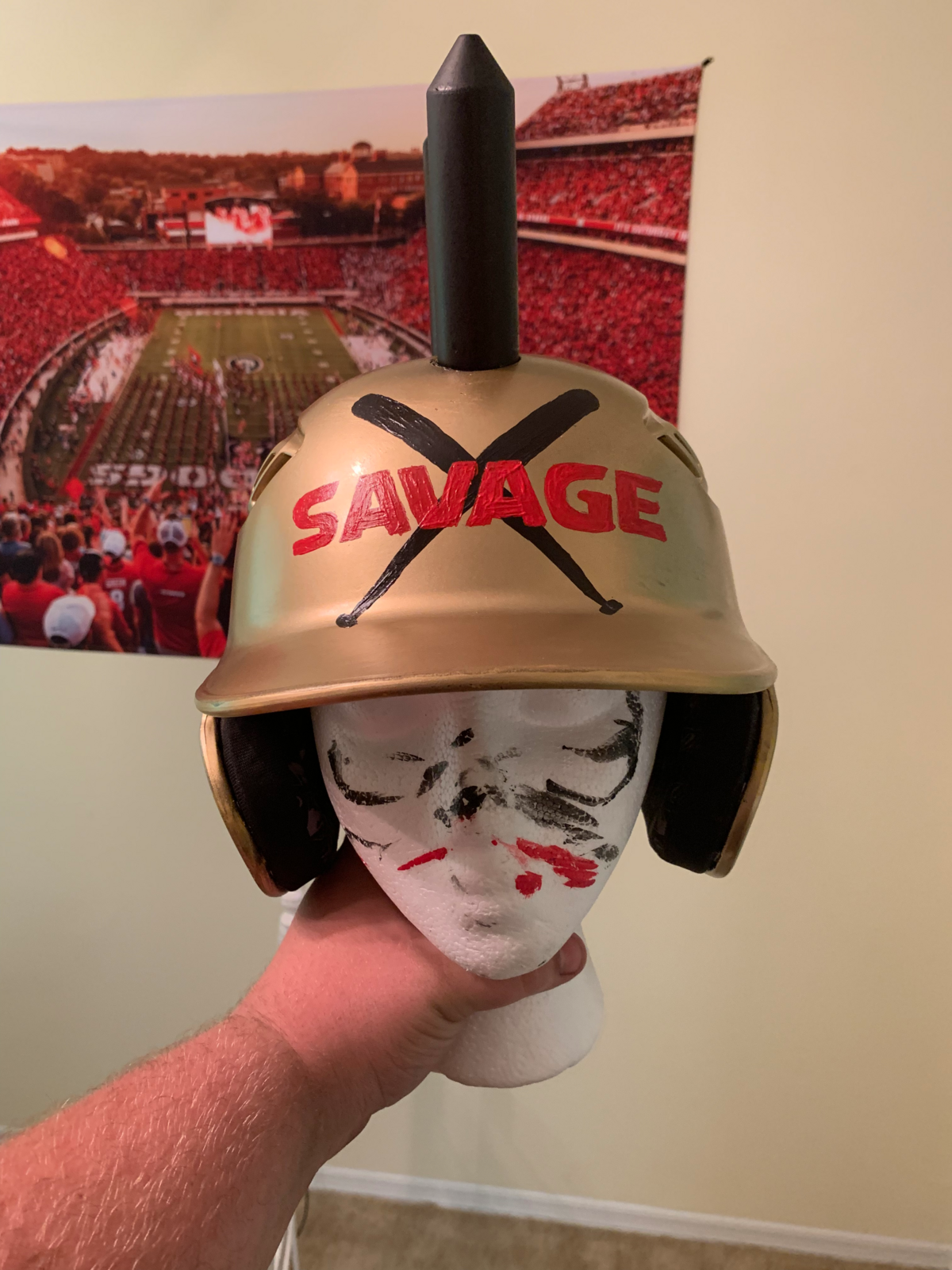 The Savage Helmet was created by Georgia baseball fans to help players celebrate home runs. It was spray painted with gold paint and adorned with six spikes.