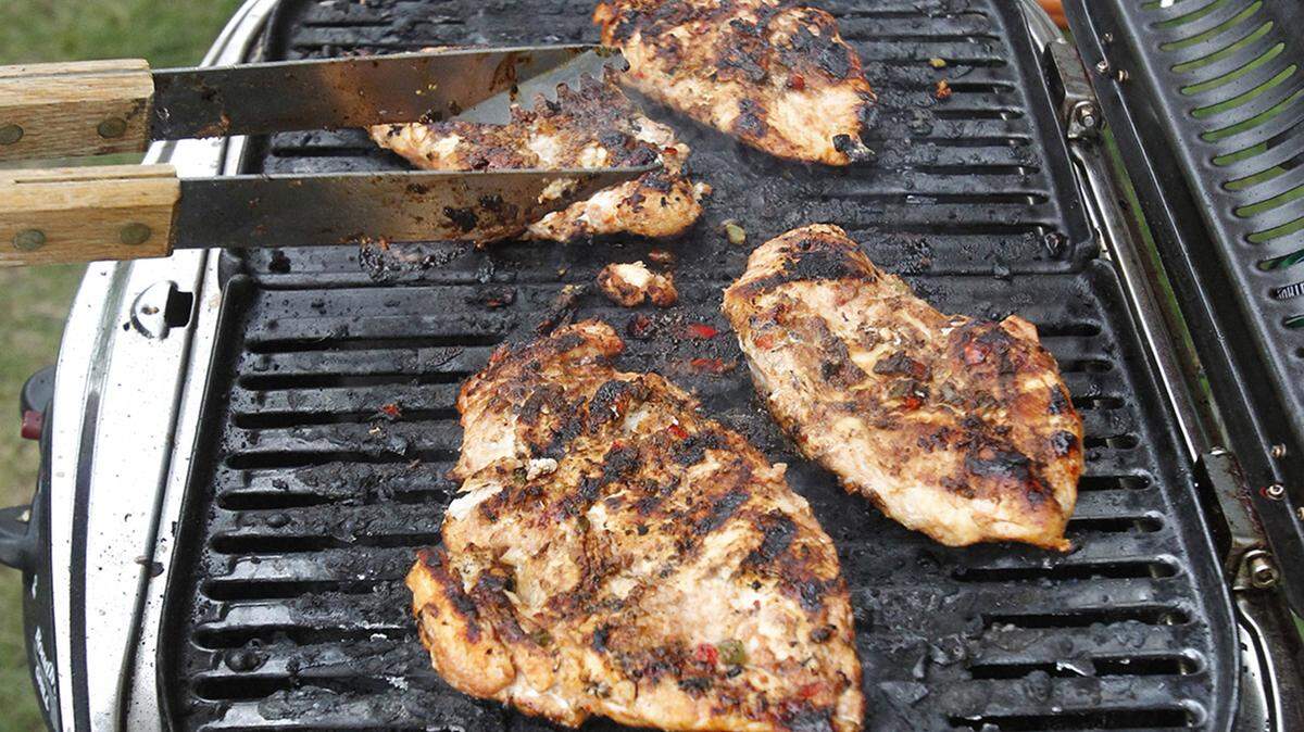 Tim Klinger grills chicken for fajitas while tailgating outside InfoCision Stadium before a University of Akron football game in Akron, Ohio.