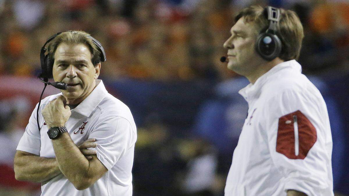 Alabama head coach Nick Saban and defensive coordinator Kirby Smart, now Georgia's head caoch, work from the sideline during the 2015 SEC Championship. 