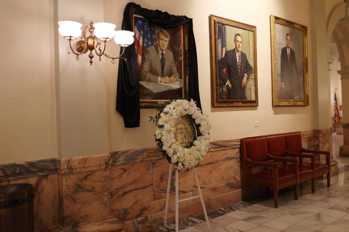 A portrait of former President Jimmy Carter sits with a black veil and a wreath on Saturday, Jan. 4, 2025, at the Georgia State Capitol in Atlanta, Georgia. Carter died on Sunday, Dec. 29, 2024, and will be honored with ceremonies throughout the state in the coming week.