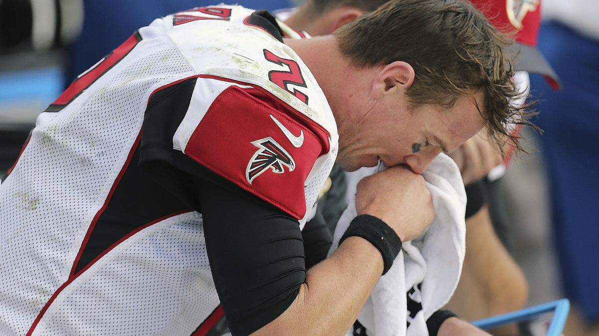 Atlanta Falcons quarterback Matt Ryan reacts on the bench after fumbling the ball away to the Carolina Panthers during the second half an NFL football game in Charlotte, N.C., Sunday, Dec. 13, 2015.