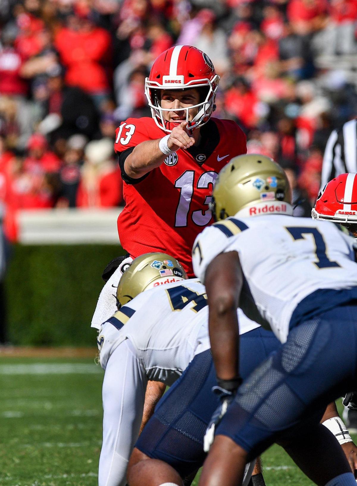 Georgia quarterback Stetson Bennett makes adjustments at the line as the Bulldogs dismantled Charleston Southern 56 -7 Saturday in Athens.