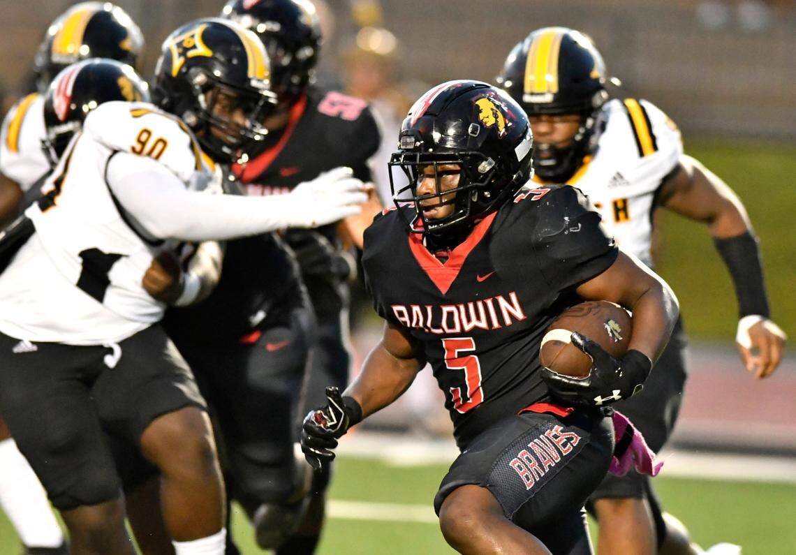 Baldwin running back Micah Welch (5) runs toward the sideline during the Braves’ game against Peach County Friday night in Milledgeville.