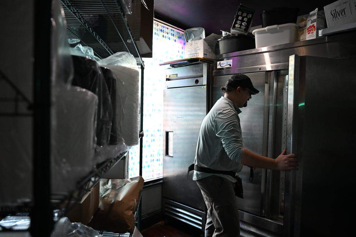 North Central Health District environmental health specialist Mark Torres-Hauck checks fridges inside of Parish on Cherry during a mock health inspection on Thursday, Sept. 18, 2025, in Macon, Georgia. A restaurant’s health inspection typically takes place every six months. 