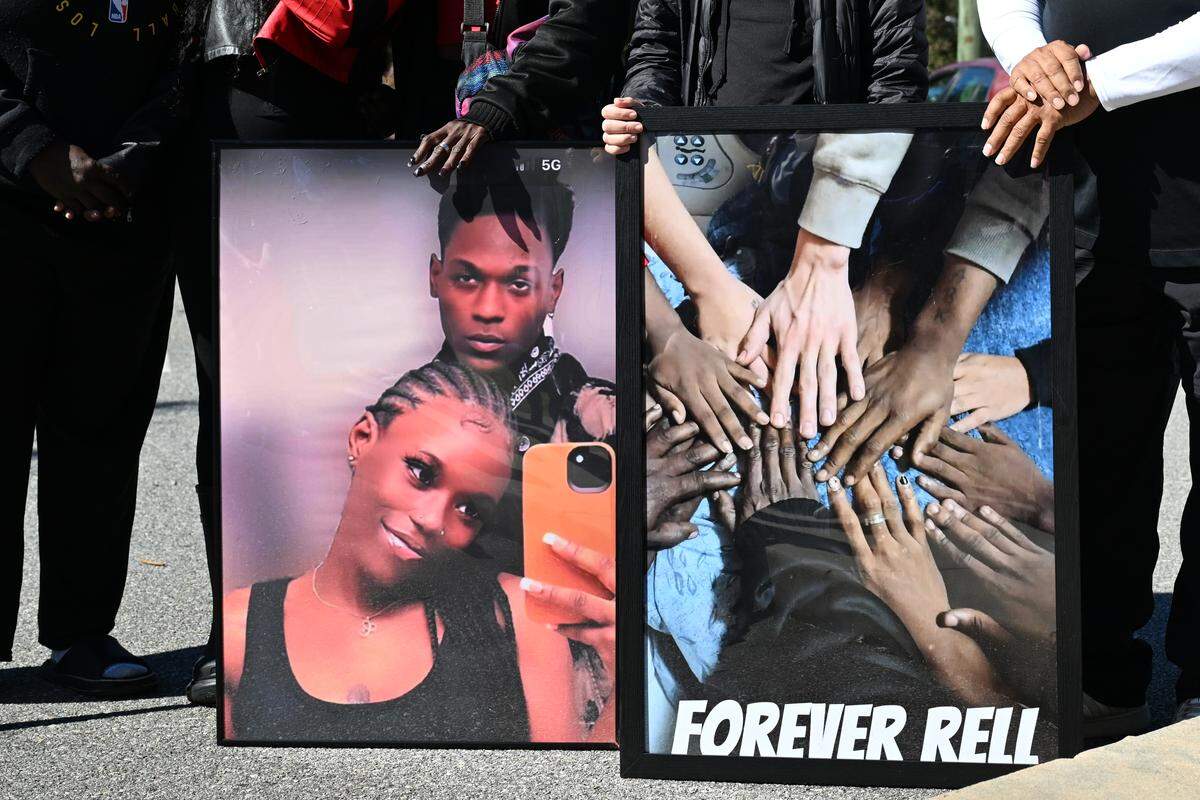 Family and friends hold a photo of 24-year-old twin siblings Contrella Dixon (left) and Contrel Dixon at a balloon release honoring Contrel’s life on Oct. 31, 2025, in Macon, Ga., after he died on Oct. 23. Contrel Dixon died from a shooting on July 4, at his home on Sparkle Avenue.