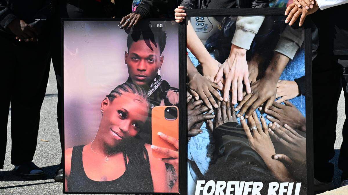 Family and friends hold a photo of 24-year-old twin siblings Contrella Dixon (left) and Contrel Dixon at a balloon release honoring Contrel’s life on Oct. 31, 2025, in Macon, Ga., after he died on Oct. 23. Contrel Dixon died from a shooting on July 4, at his home on Sparkle Avenue.