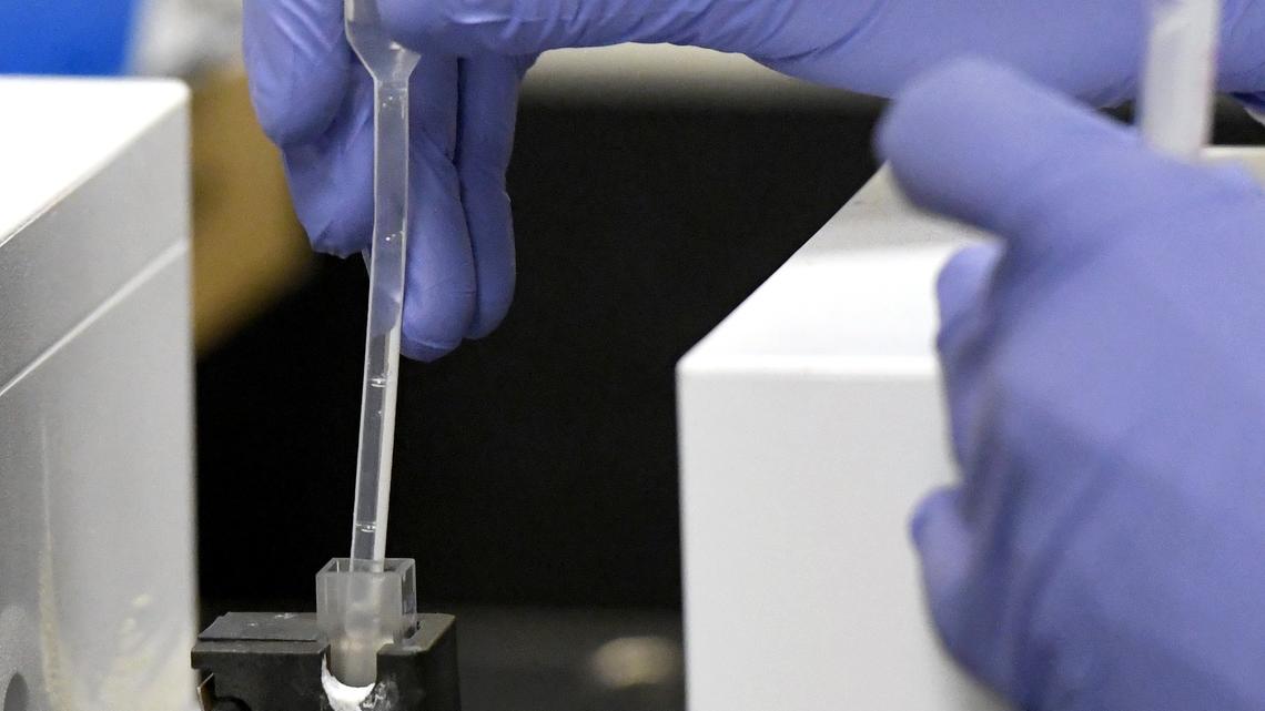 Drug chemist Brandon Hicks performs an initial drug test Friday morning at the GBI Central Lab in Dry Branch.