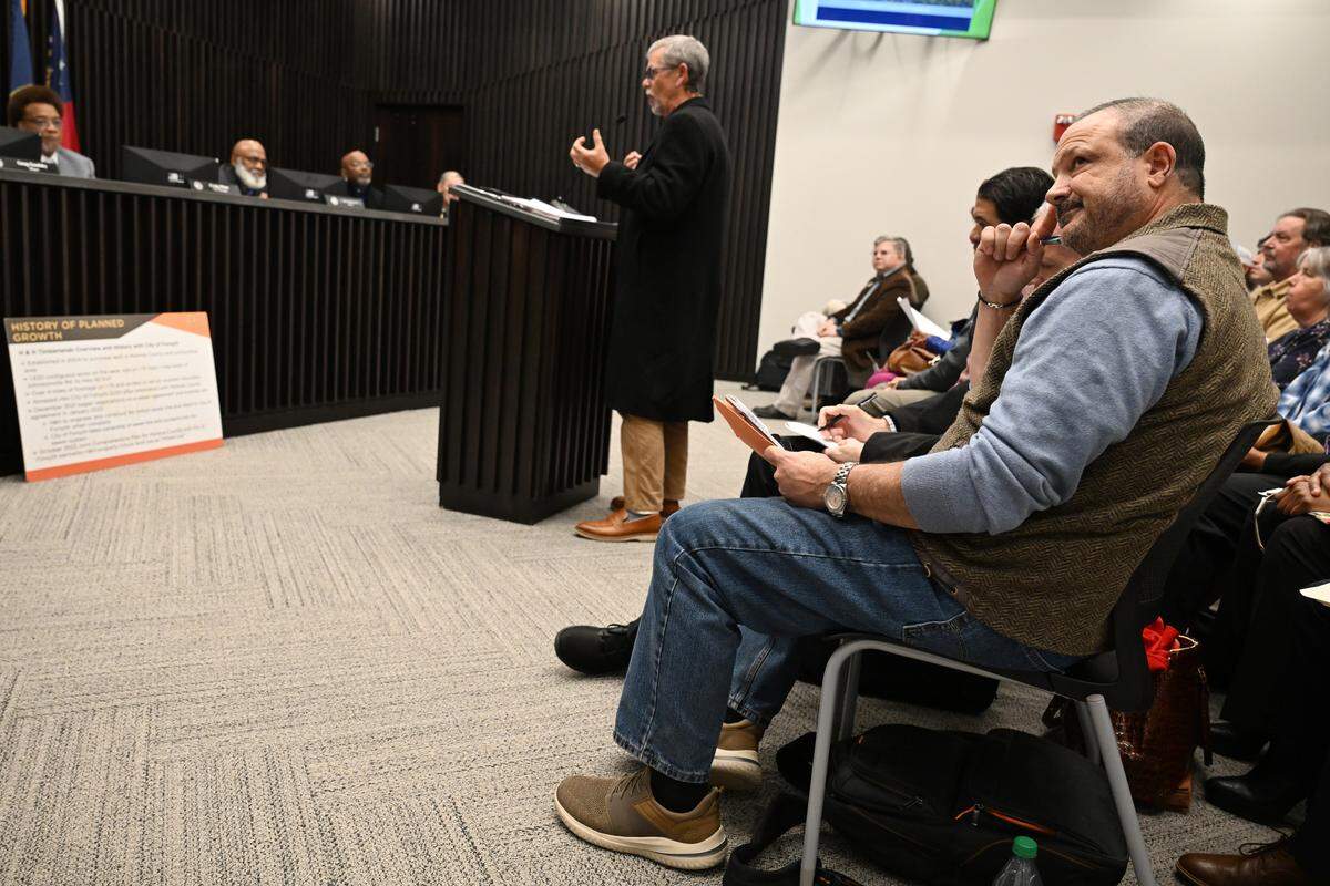 H&H Timberlands co-owner Tye Hanna (right) reacts during public comment in opposition to the rezoning request for land for a proposed data center on Monday, Feb. 2, 2026, at Forsyth City Hall in Forsyth, Georgia. Forsyth city council voted unanimously to rezone part of the site back to agricultural land and voted 5-1 to approve a conditional use application, which allows data centers in agricultural zones and will move the Johnstonville Road data center project forward. 
