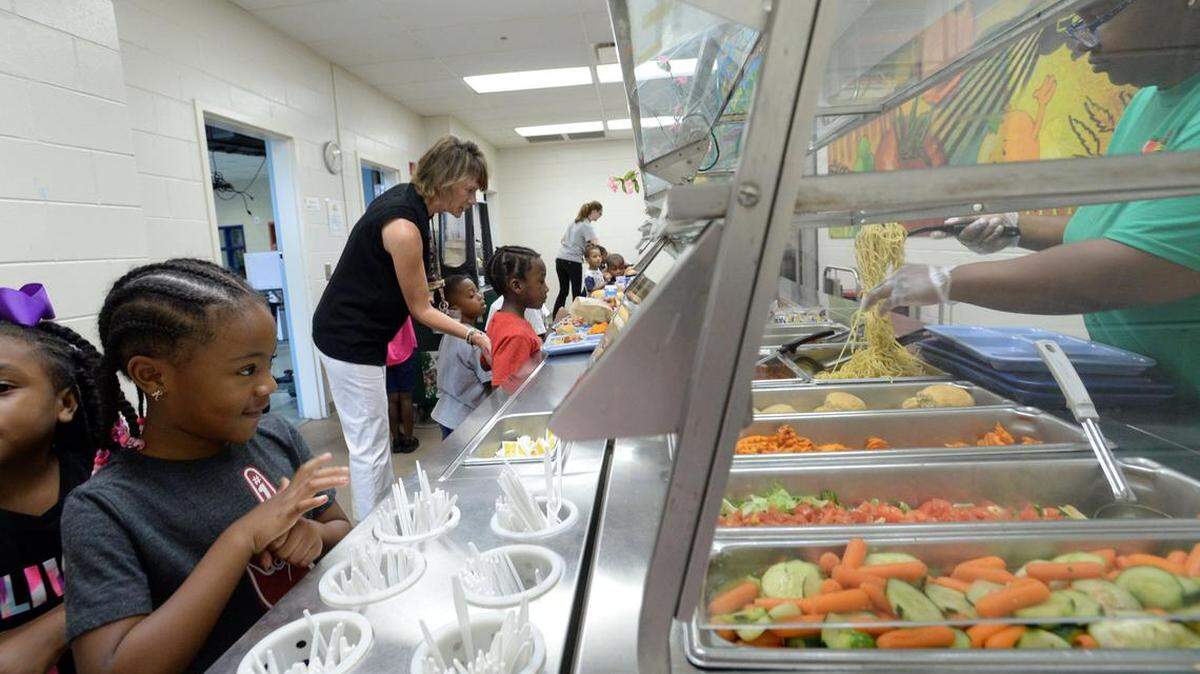 Alexander II Magnet School kindergartener Rylee Davis, left, says she loves spaghetti as she goes through the lunch line.