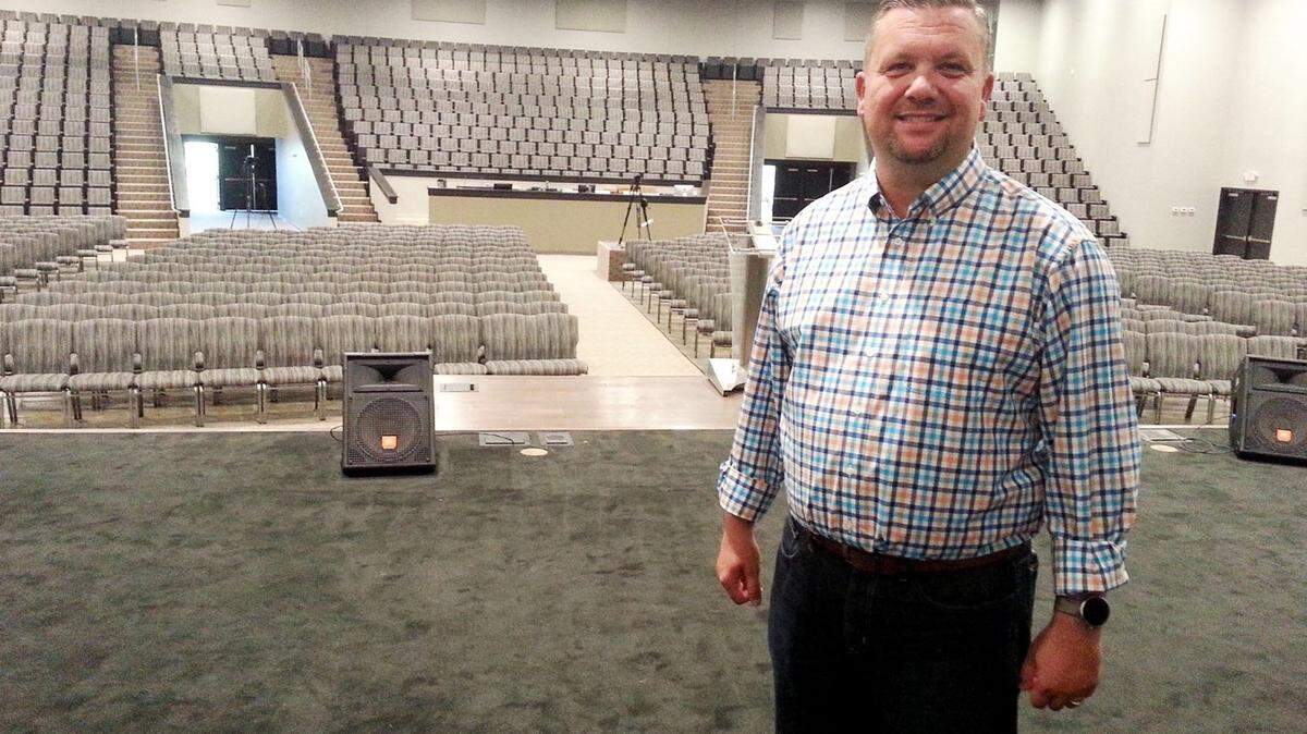 Mark Merrill, lead pastor at The Assembly at Warner Robins stands on stage in the church’s new 1,300 seat sanctuary.