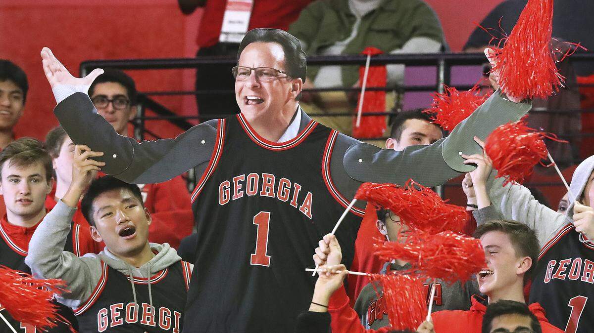 Georgia fans hold a cut out of head coach Tom Crean while cheering the team against Texas A&M during a 63-48 Georgia victory in a NCAA college basketball game on Saturday, Feb. 1, 2020, in Athens.